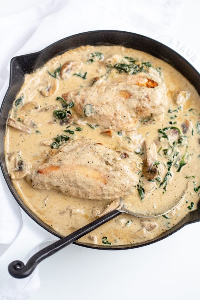 Skillet with chicken in a creamy sauce.