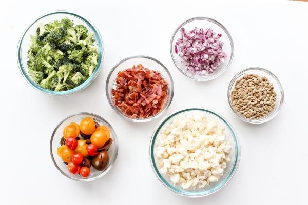 Vegetables, bacon and sunflower seeds in bowls