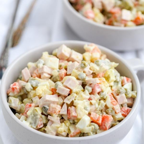 Russian Salad in a bowl, another bowl in background