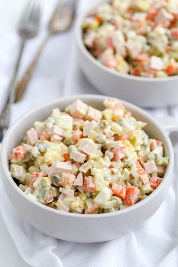 Russian Salad in a bowl, another bowl in background