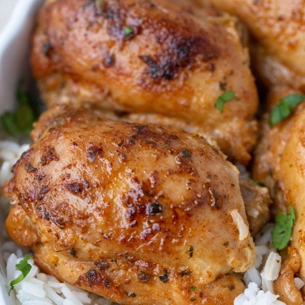 Instant Pot Chicken, Thighs on a plate with rice.