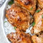 Instant Pot Chicken Thighs on a plate with rice.