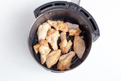 Seasoned chicken wings in an air fryer