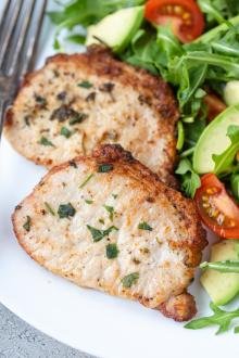 Air Fryer pork chops on a plate with salad