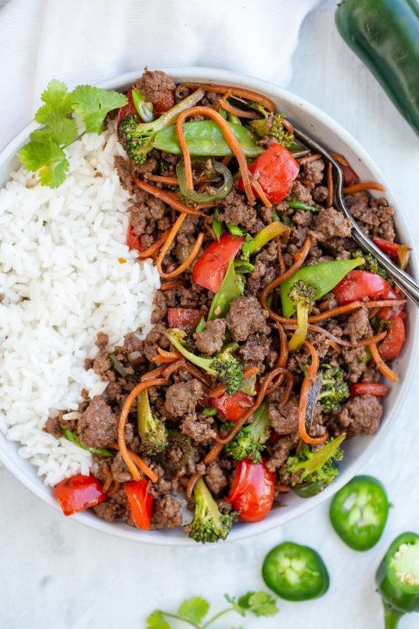 korean Beef Stir Fry on top of rice in a bowl