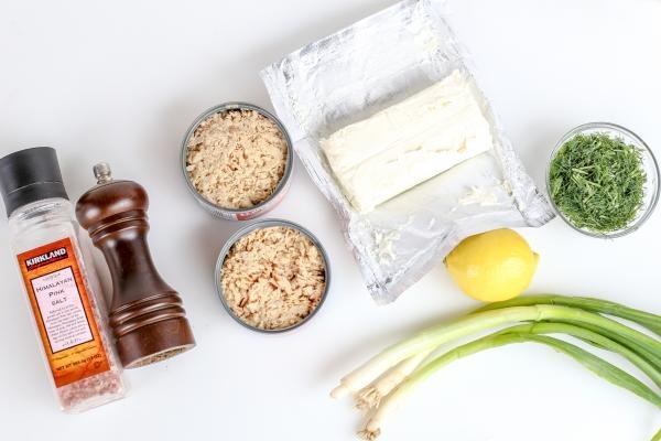 Ingredients for salmon dip on a white board