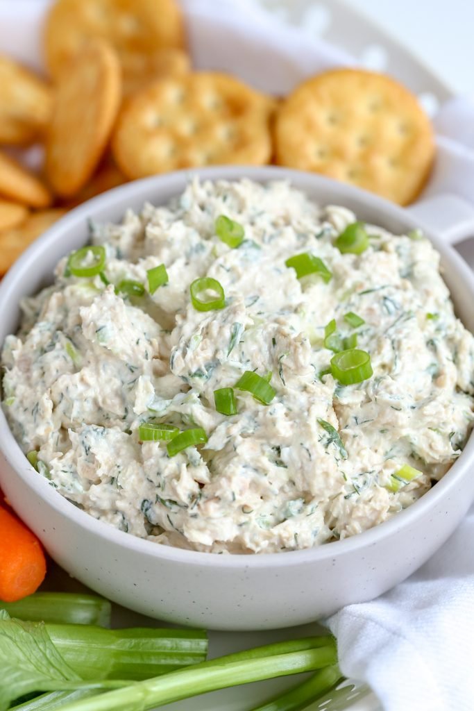 Canned Salmon Dip in a bowl with crackers and veggies