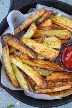 Air fryer french fries in a plate with ketchup