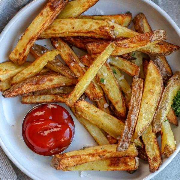 Air fryer french fries in a bowl with ketchup