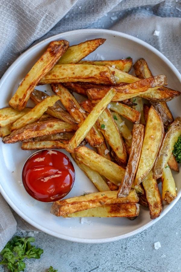 Air fryer french fries in a bowl with ketchup