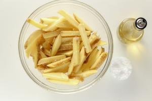 Bowl with fries and salt and oil