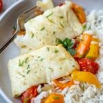 Plate with baked cod and plate with rice