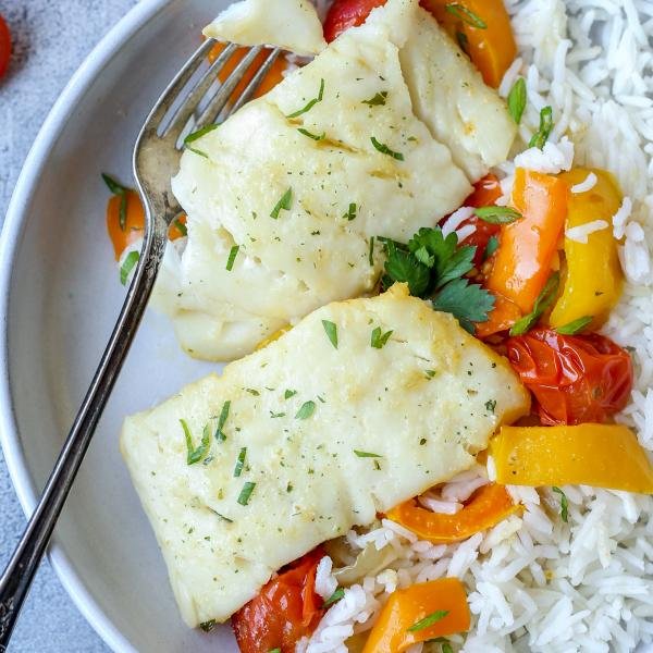 Plate with baked cod and plate with rice