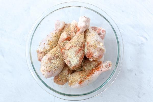 Seasoned chicken legs in a bowl