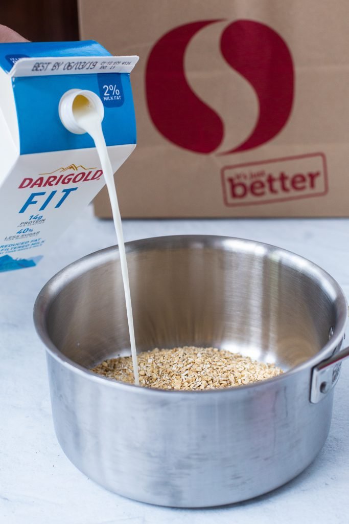 Darigold fit milk pouring into pot with oatmeal