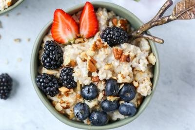 Old Fashioned Oatmeal Pudding in a bowl with berries
