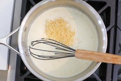 Pot with cream and and parmesan in a cooking pot