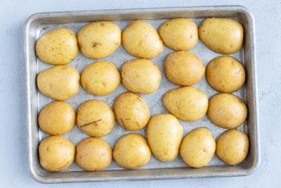 Half cut Potatoes on a baking sheet