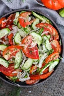 Garden Cucumber Tomato Salad in a bowl with a towel