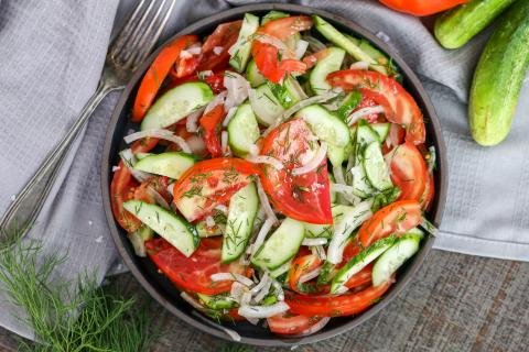 Garden Cucumber Tomato Salad in a bowl with a towel