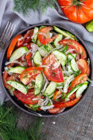 Tomato cucumber salad in a plate.