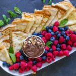 Crepes on a tray, berries and nutella