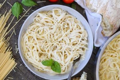 Alfredo pasta in a plate with other pasta ingredients