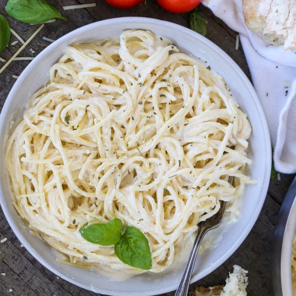 Alfredo pasta in a plate with other pasta ingredients