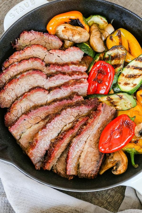 Brisket with grilled veggies in a skillet