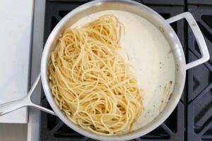 Pasta with alfredo sauce in a pan.