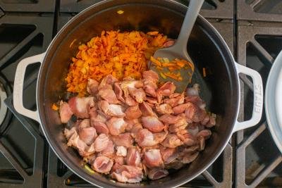 Gizzards with sauteed carrots and onions in a cooking pot