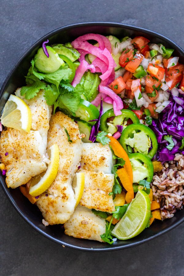 Air fryer cod in a bowl with veggies and rice
