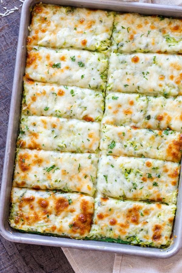 Cheesy bread sticks on a baking sheet