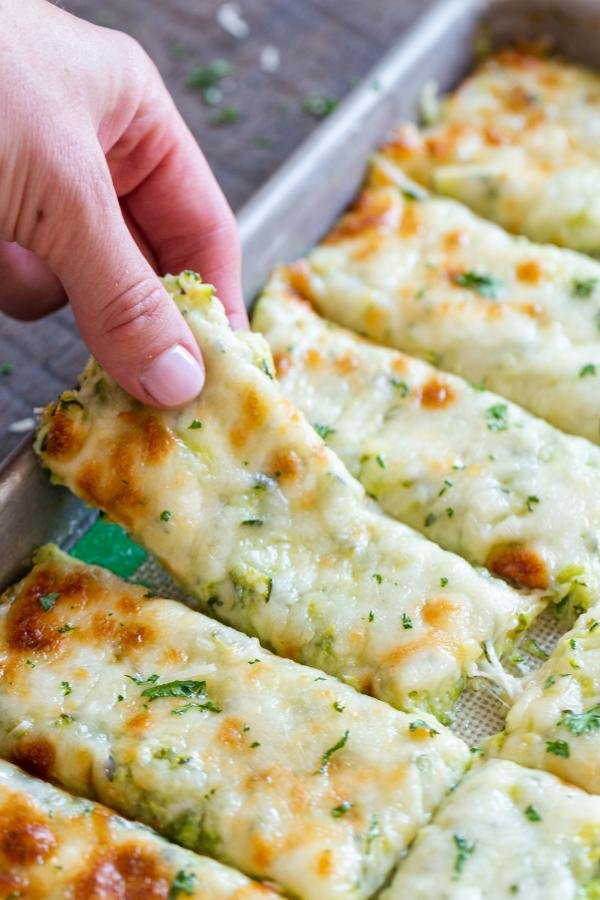 Cheesy bread sticks on a baking sheet