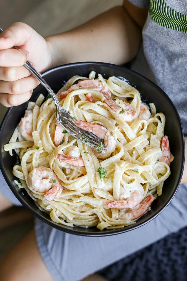 Creamy shrimp scampi in a hand a child