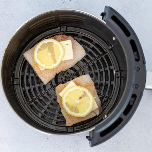 Cod in airfryer basket with cod and lemon