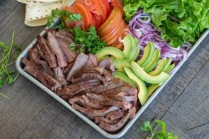 tray with flank steak and vegetables for the wrap