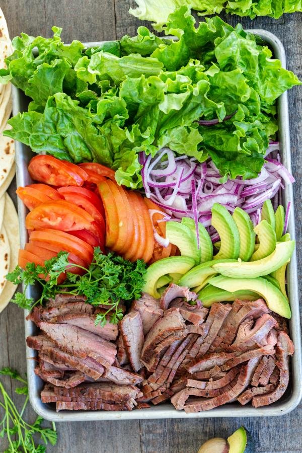 Flank steak with other vegetables on the tray ready for wraps