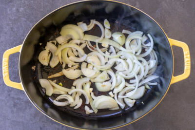 Onions cooking in a pan.