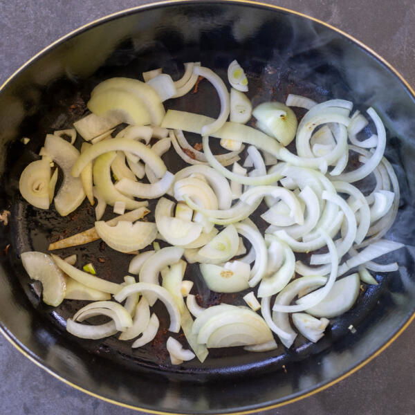 Onions cooking in a pan.