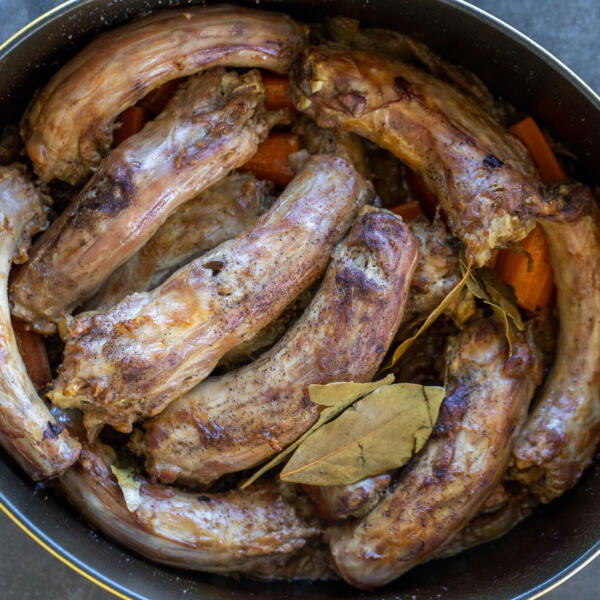 Cooked Turkey Necks in a pan.