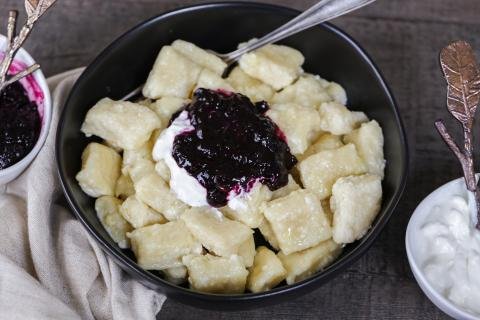 Lazy Pierogi in a bowl with jam and sour cream