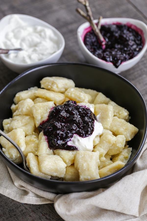 Lazy Pierogi in a bowl with jam and sour cream 