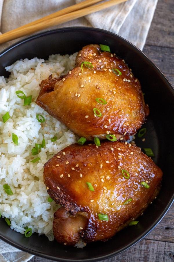 Korean Chicken Thighs in a bowl with rice