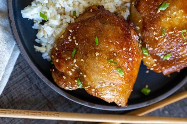 Korean Chicken Thighs in a bowl with rice