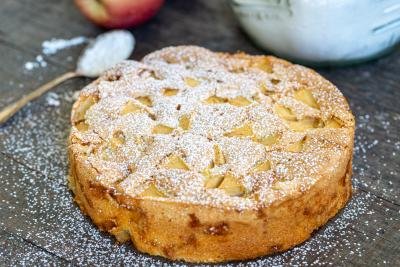 Apple cake on the counter with powdered sugar