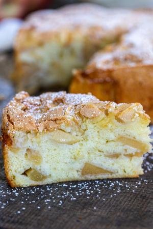 A slice of apple cake with powdered sugar