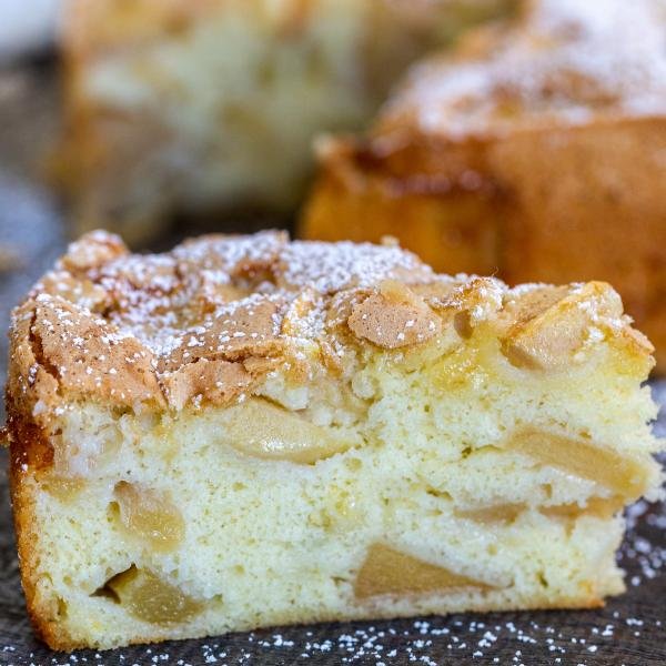 A slice of apple cake with powdered sugar