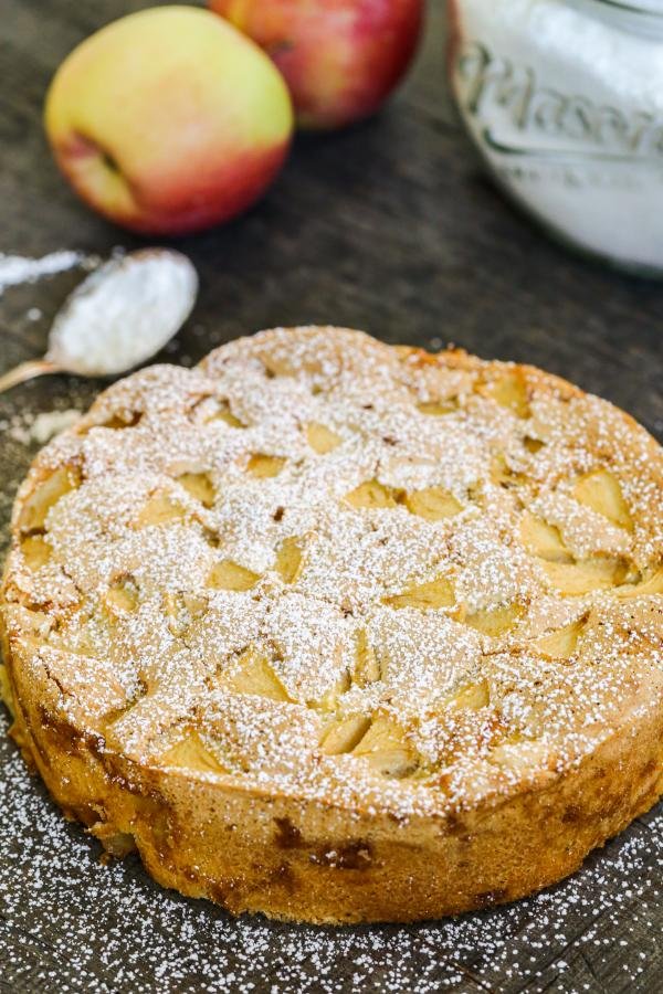 Apple cake on the counter with powdered sugar