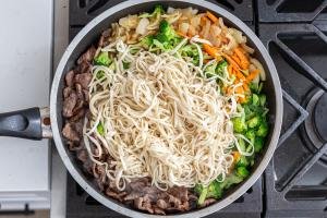 noodles with beef and veggies in a skillet